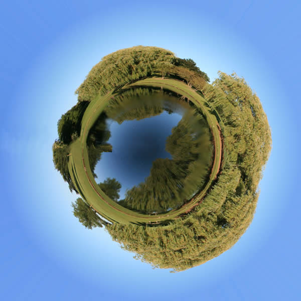 a panoramic image of a lake or pond digitally altered to appear as an island.