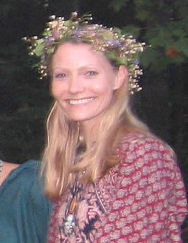 photograph of the author, a blond, caucasian woman, wearing a wreath of flowers