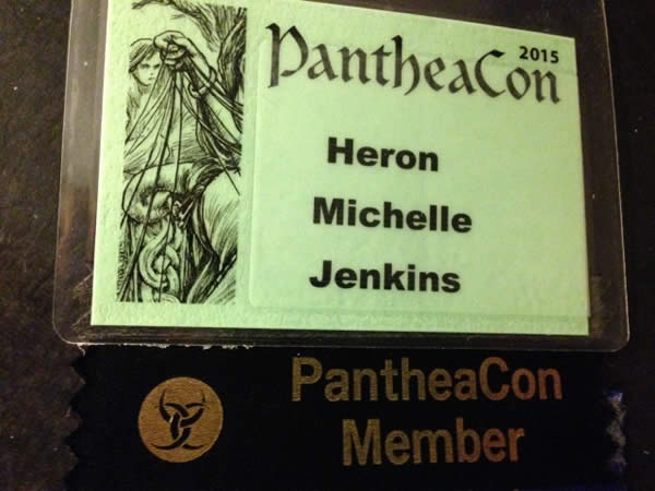 a green, laminated name tag for the author's visit to PantheaCon