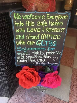 a sign reading "we welcome everyone into this safe haven with love and respect and stand united with our GLBTQ Sojourners for equal rights protection and opportunities under the law" by the "Sojo" management