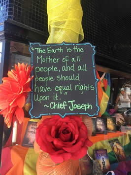a sign reading "the Earth is the Mother of all people and all people should have equal rights upon it" by Chief Joseph