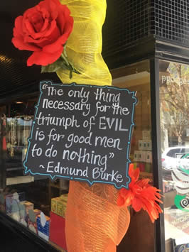 a sign reading "the only thing necessary for the triumph of evil is for good men to do nothing" by edmund burke