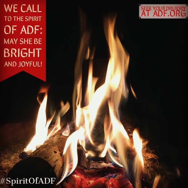 A campfire with the following phrases around it:  (1) "We call to the spirit of ADF: may she be bright and joyful!" (2) "Seek your Druidry at adf.org" (3) "#SpiritOfADF"