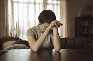 Pretty young woman sitting and sad