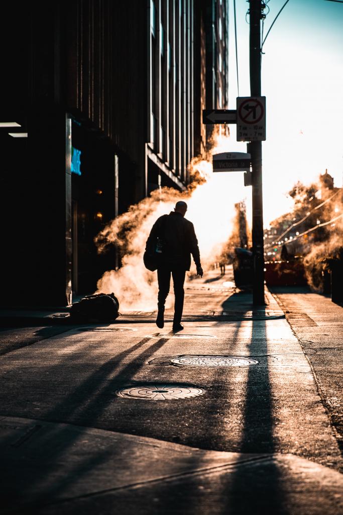 Man walking on a chilly morning to work.