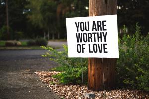 Sidewalk sign saying You Are Worthy of Love
