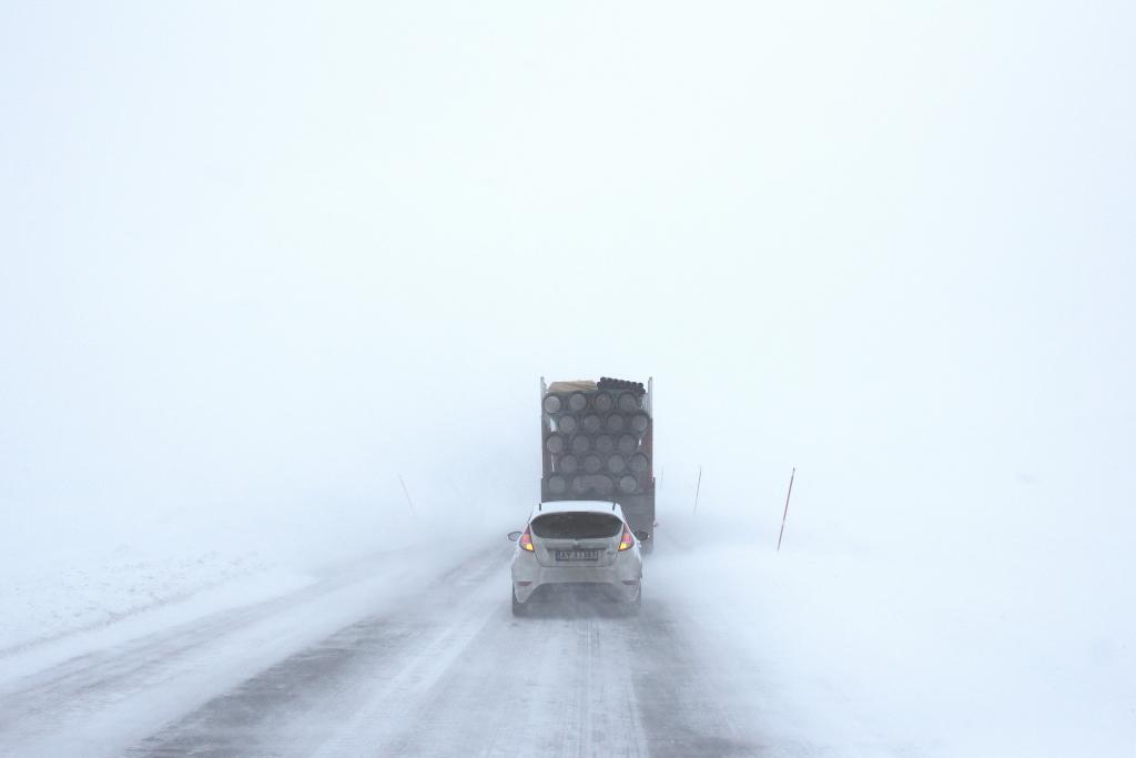 Cars driving through a blizzard.