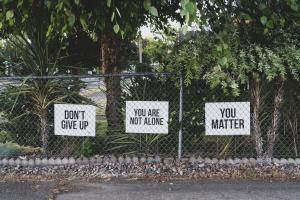 Fence with white signs