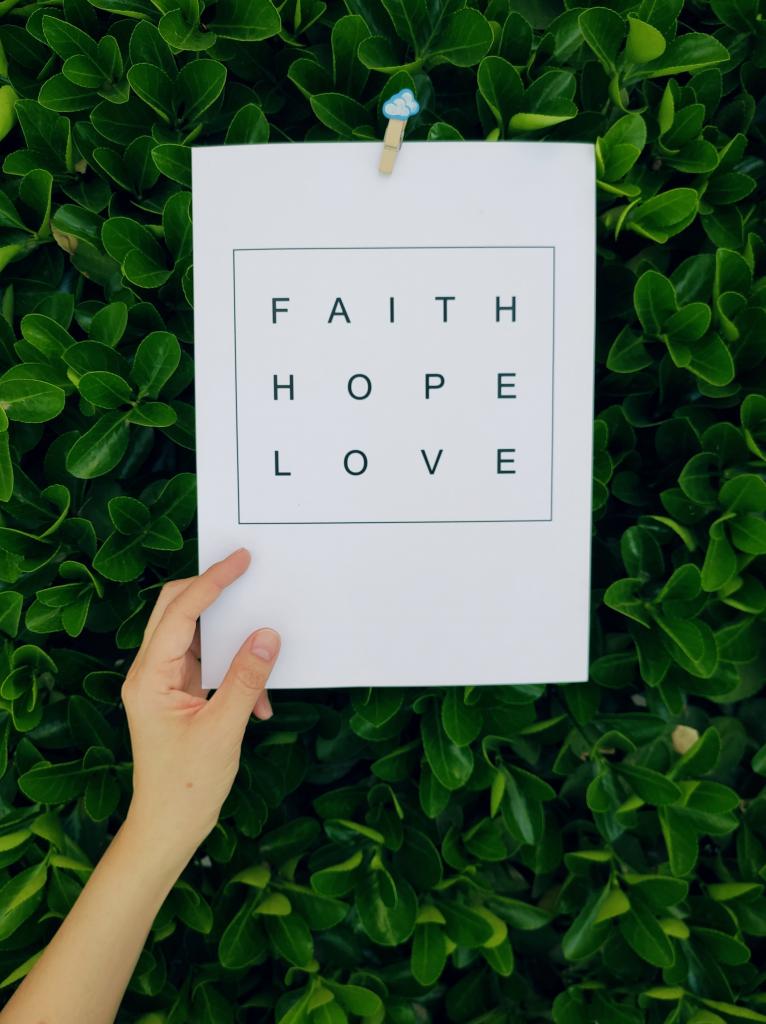 Sign with words, faith, hope, love on it.