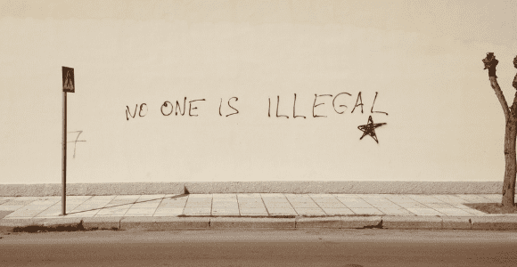 Wall with writing that states, "No one is illegal."