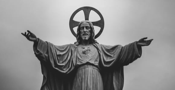 grayscale photograph of Jesus Christ statue