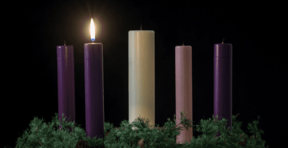 candle lit for first Sunday of advent