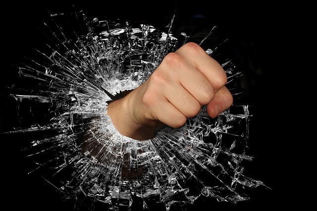 fist punching through glass represents the nastiness on the Internet