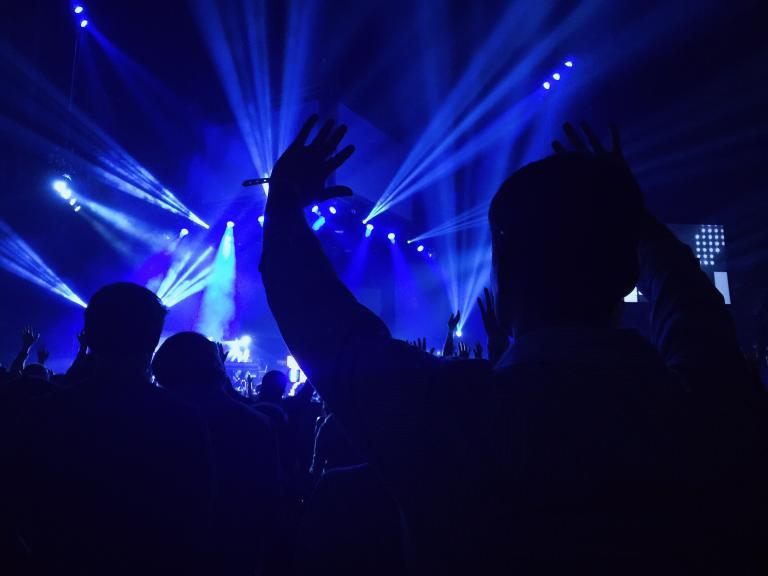 a person raising their hands and praising God.