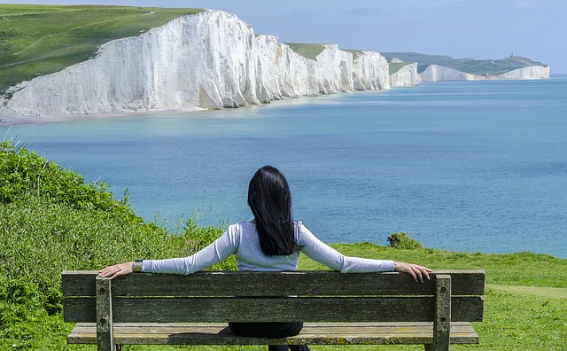 a woman who is weary and burdened relaxing on a bench