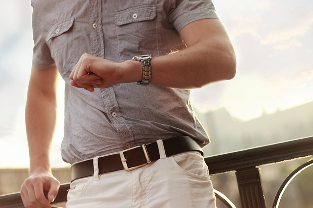 man checking his watch. If you're frustrated that God isn't answering your prayers, give him some time.