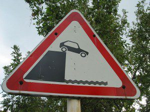 Car off cliff sign by BorisFromStockdale. CC license 3.0