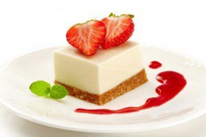 a plate of strawberry cheesecake