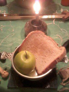 An offering of bread and an apple to the liminal Gods