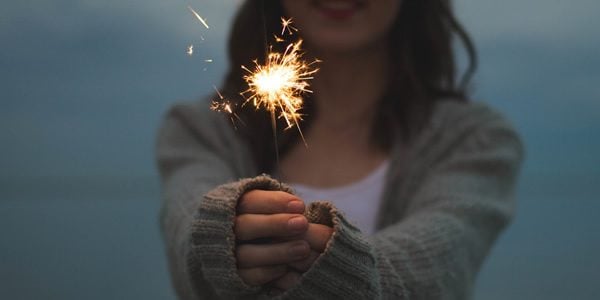 a woman holding a sparkler