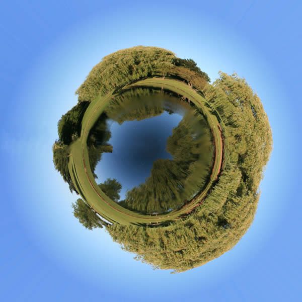 a panoramic image of a lake or pond digitally altered to appear as an island.