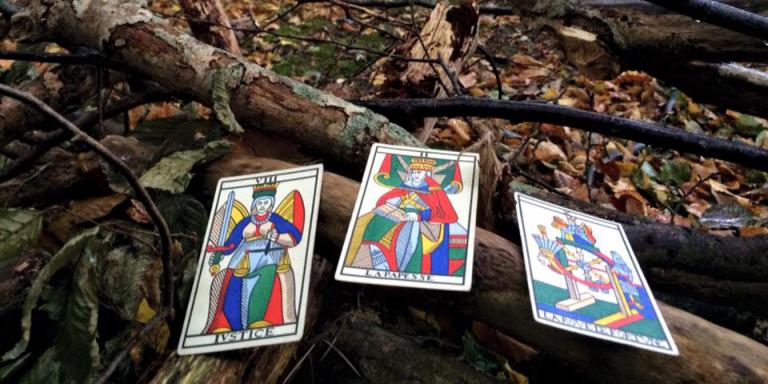 Three tarot cards pictured on the ground 
