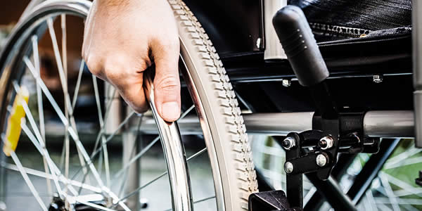 Paralyzed man using his wheelchair