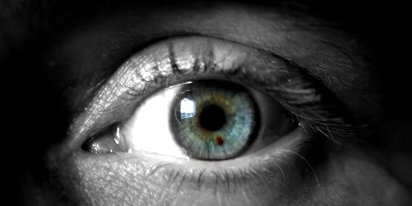a close-up image of a blue, green human eye