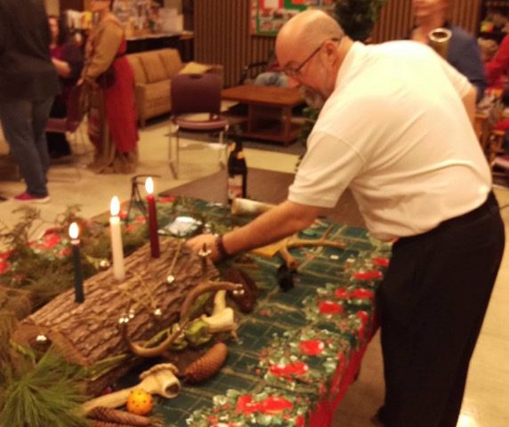 Oengus Sea Eagle, Senior druid of the Sinnisippi Tuath Grove, adjusting our Yule log /  Photo by Kara Sigrun