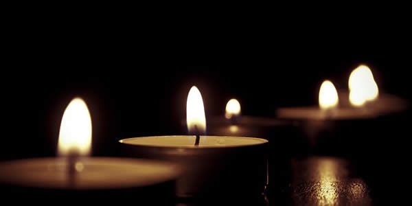 lit tealights in a dark room