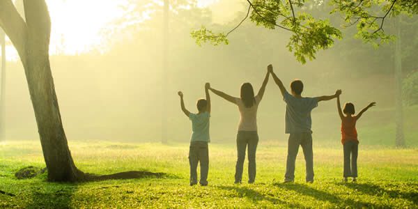 a family in the park during a beautiful sunrise, backlight