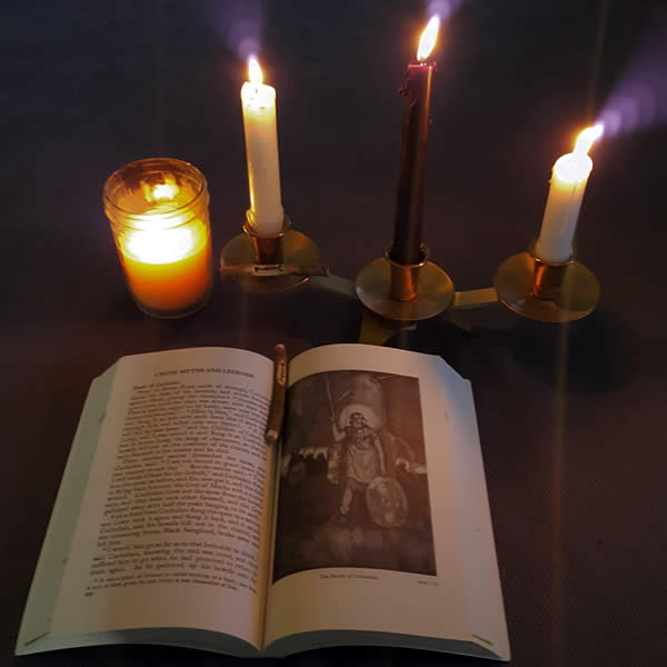 a candle lit open book