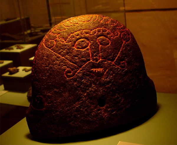 a stone carved with a depiction of Loki