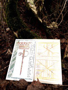 two tarot cards placed on the ground before a tree root