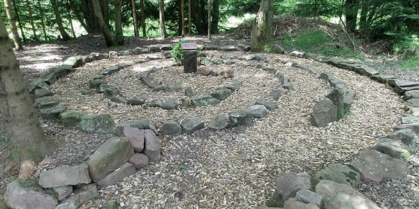 a labyrinth made of stones with an altar in the center