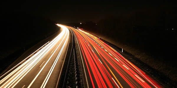 the lights of cars streaking in the night due to a long exposure with a camera