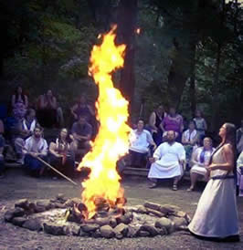 a group photograph showing ritual attendees around a fire