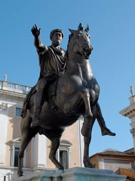 the figure of a bearded man astride a horse pointing into the distance