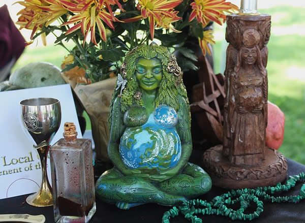 a Wiccan altar with an Earth goddess statue upon it
