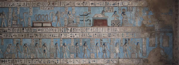 a hieroglyphic series of Egyptian figures performing acts of worship