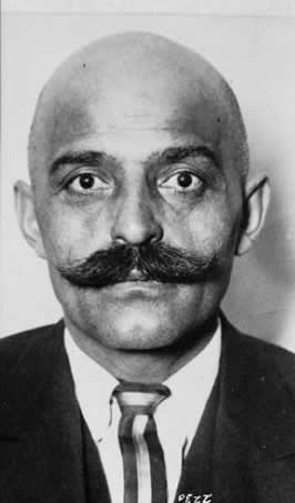 photograph of Georges Gurdjieff, a bald man with a large mustache in a suit and tie