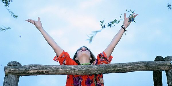 a woman throwing flowers to the wind