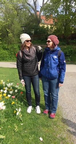 Two women dressed in warm, outdoor clothes embrace.