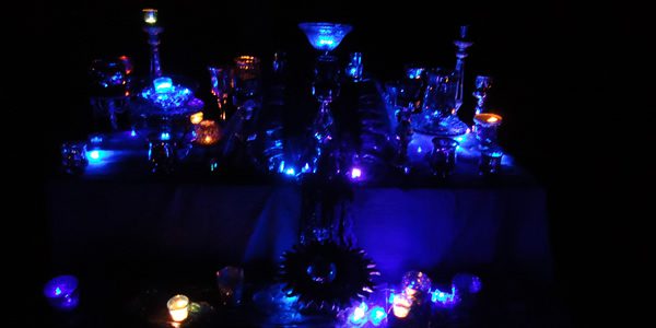 an altar illuminated by small candles in an otherwise dark room