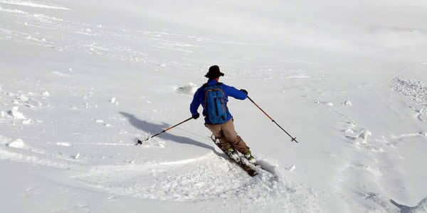 a man downhill skiing