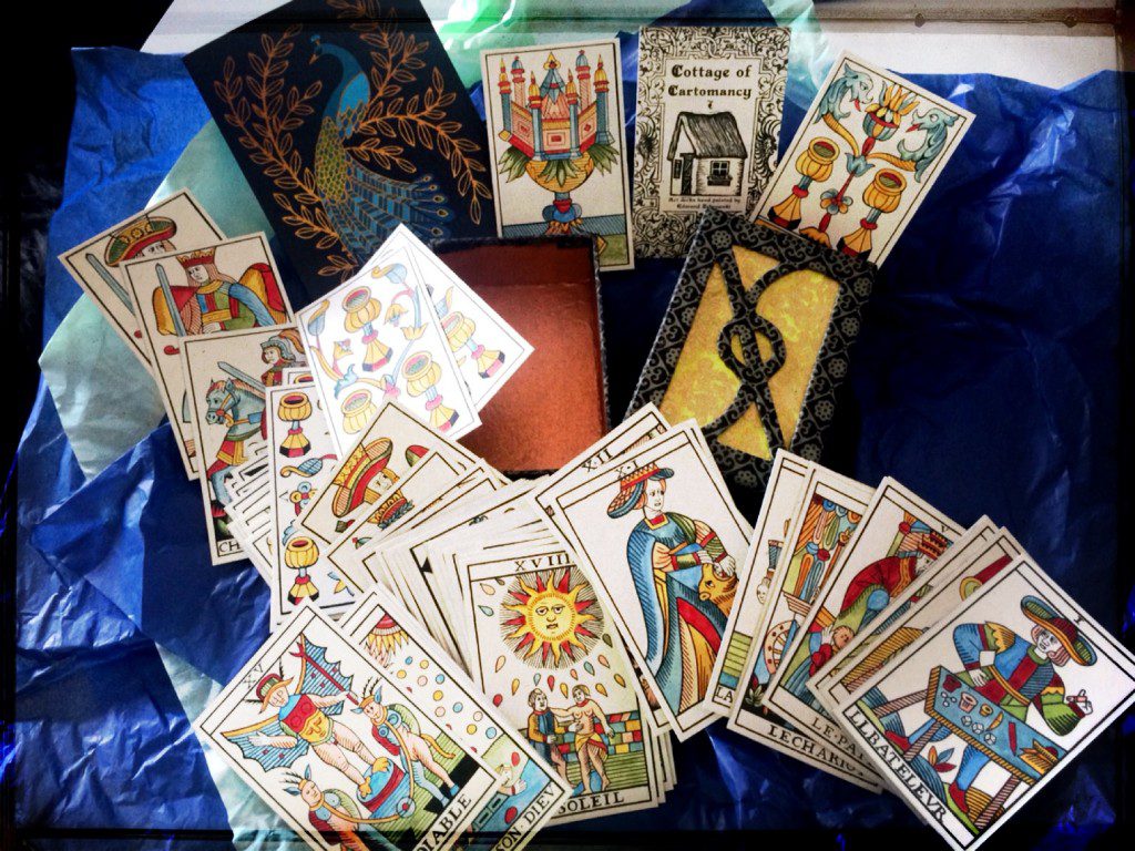 tarot cards poured haphazardly out on a table