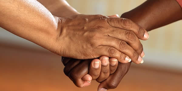 a photograph of clasped hands