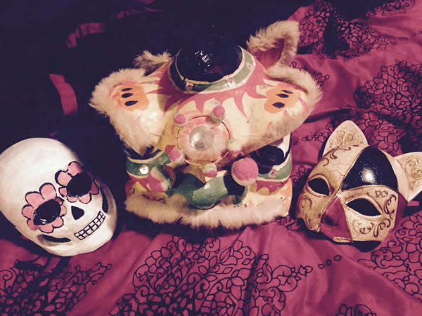 three masks displayed on a red cloth