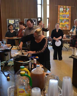 a group of people selecting food at a feast