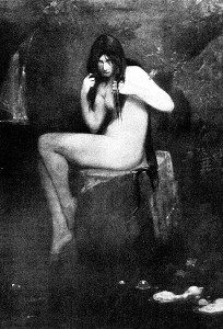 a seated naked woman peering through the bangs of her long hair